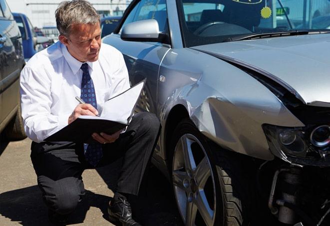 woman comparing auto insurance quotes on laptop